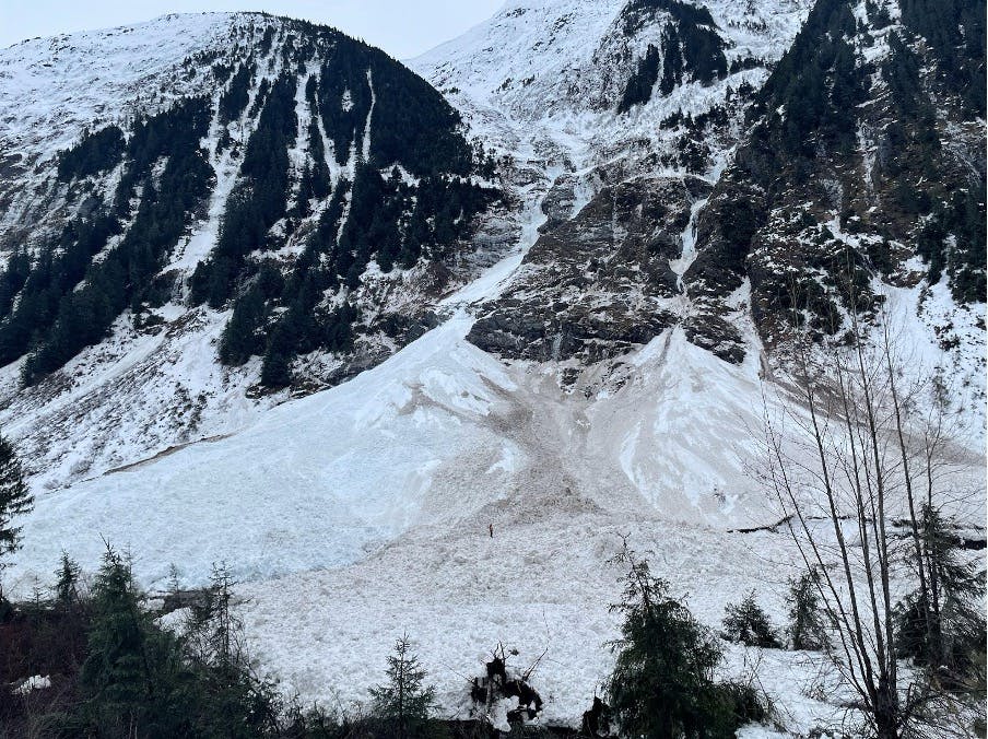 A large wet loose avalanche has run beneath a rocky area. The debris is discoloured by mud.