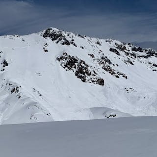 a large avalanche that has propagated across a variety of alpine terrain features