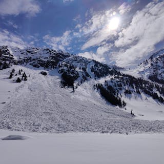 A large wet avalanche starting in a rocky area
