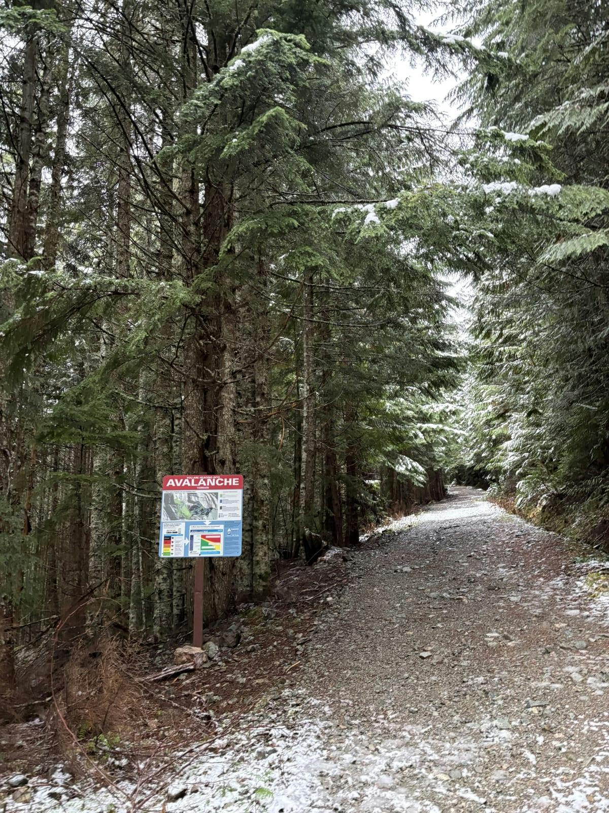 a trailhead with a dusting of snow on the ground