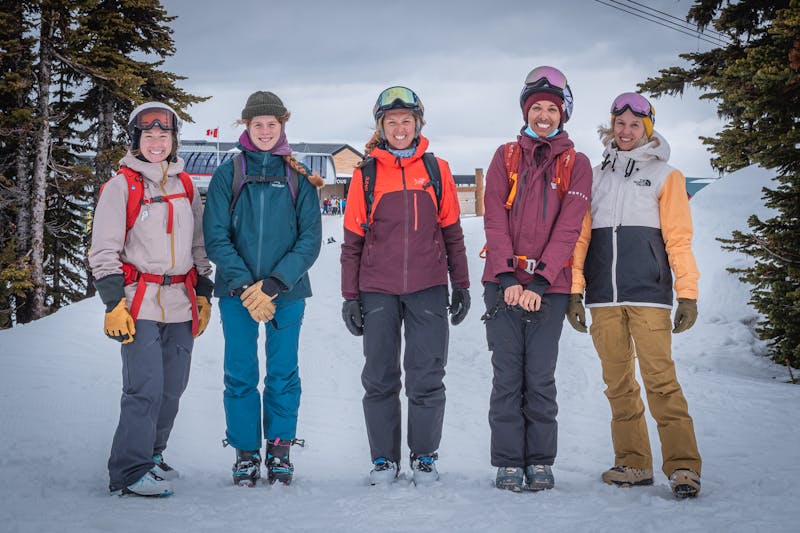 Five members of Mountain Mentors smiling in front of a ski resort.