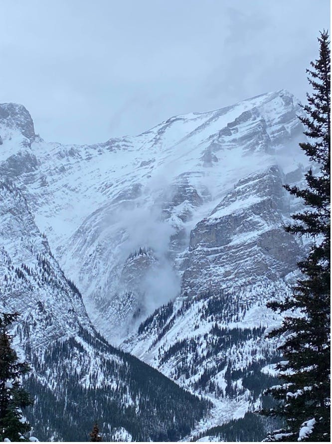 Image shows an avalanche over the Saddam's Insane climb, taken from Wedge Smear