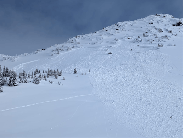 An avalanche in steep, rocky, shallow terrain that has run into more mellow terrain beneath.