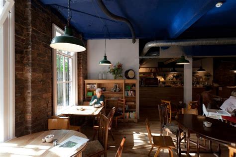 Woman enjoying coffee in The Glad Cafe in Glasgow