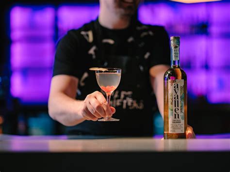 A bartender at Shapeshifters bar serving an Avallen cocktail