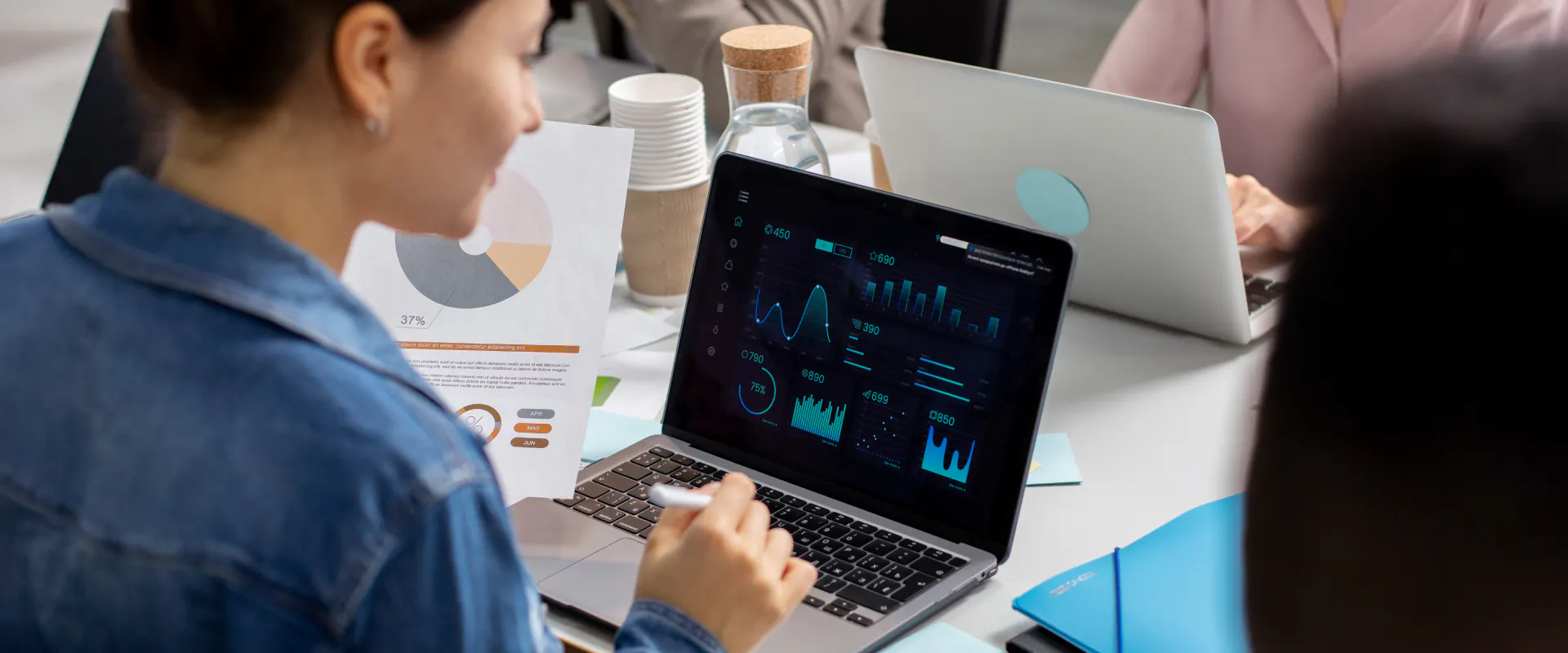 A business team reviewing operational data on a laptop, representing technology and decision-making in private aviation.