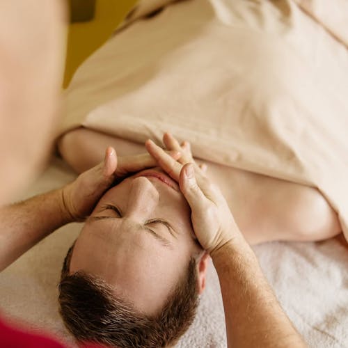 Ayurvedische Gesichtsmassage bei einem Patienten der Ayurveda-Klinik