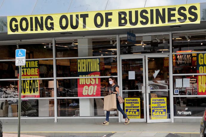 A customer leaves a Pier 1 retail store, which is going out of business, during the coronavirus pandemic, Thursday, Aug. 6, 2020, in Coral Gables, Fla. The home goods retailer is going out of business and is permanently closing all of its stores.