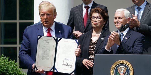 President Donald Trump signs a bill to extend the PPP small business lending program.