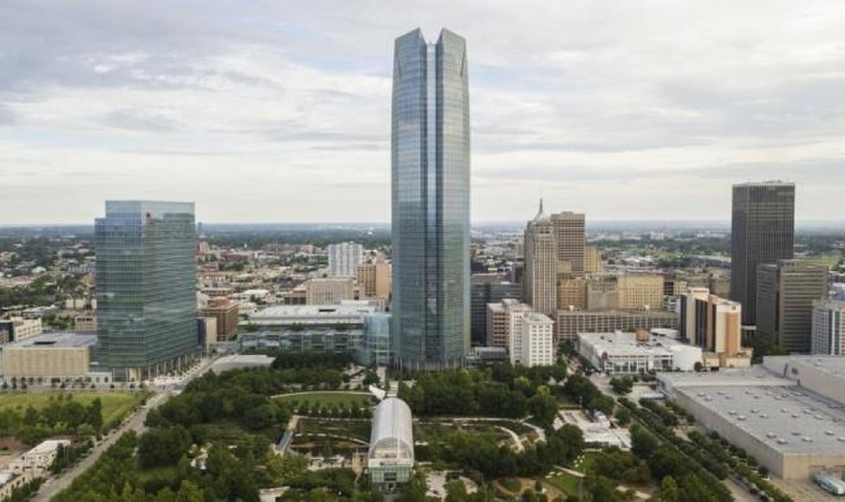 A picture of Devon Energy's headquarters, the Devon Energy Center, towering over the Oklahoma City skyline
