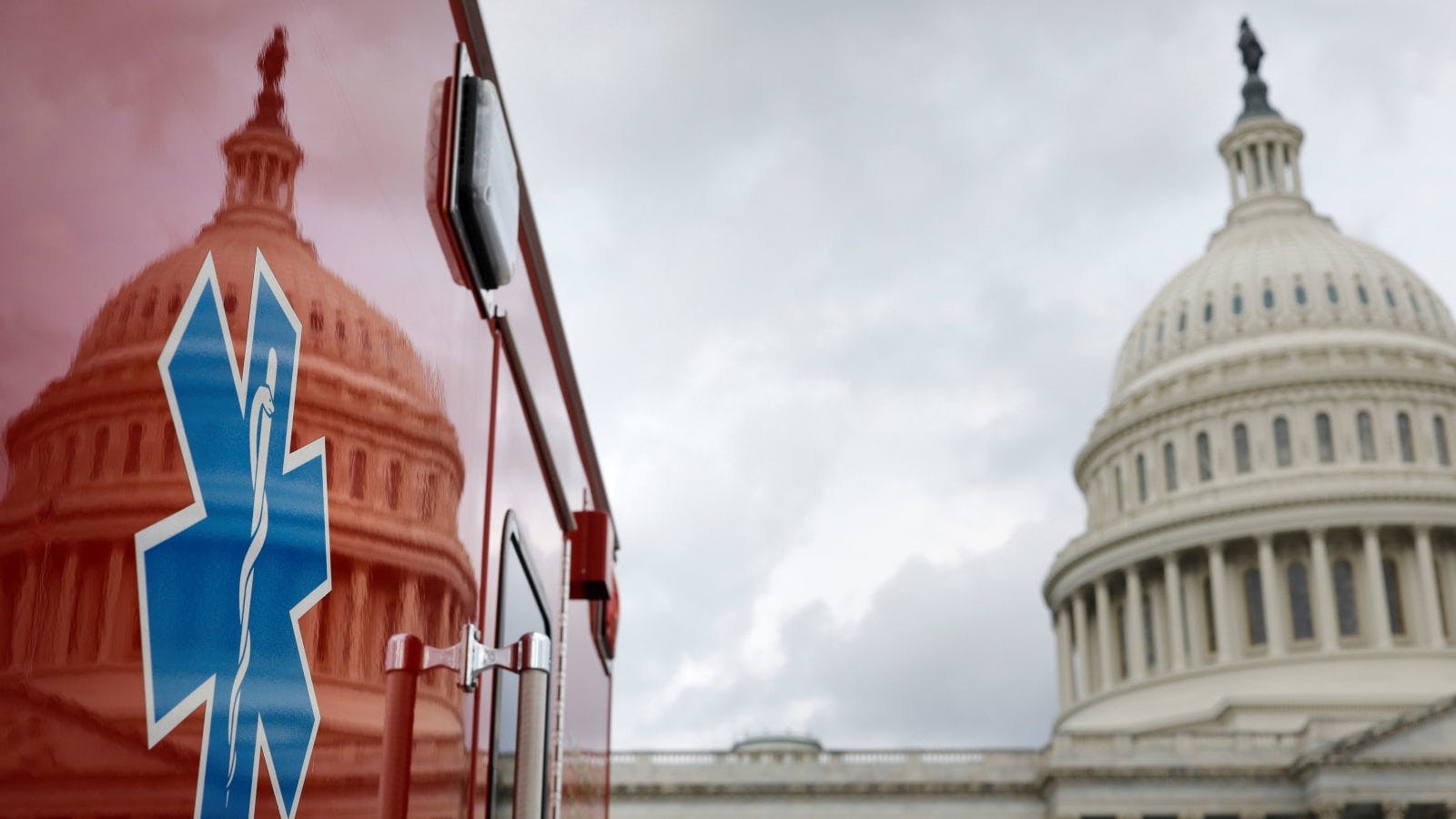 An ambulance parked next to the U.S. Capitol building.