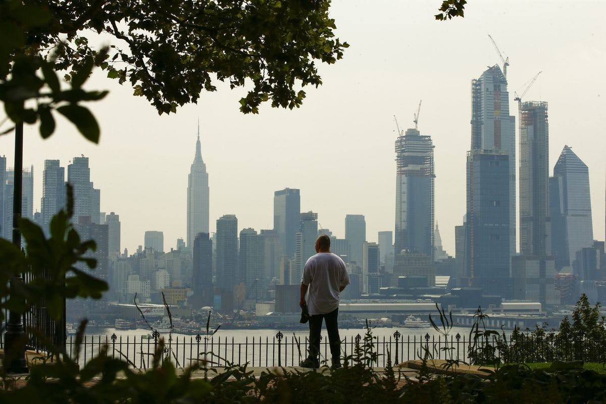 Man looks at view of New York City skyline