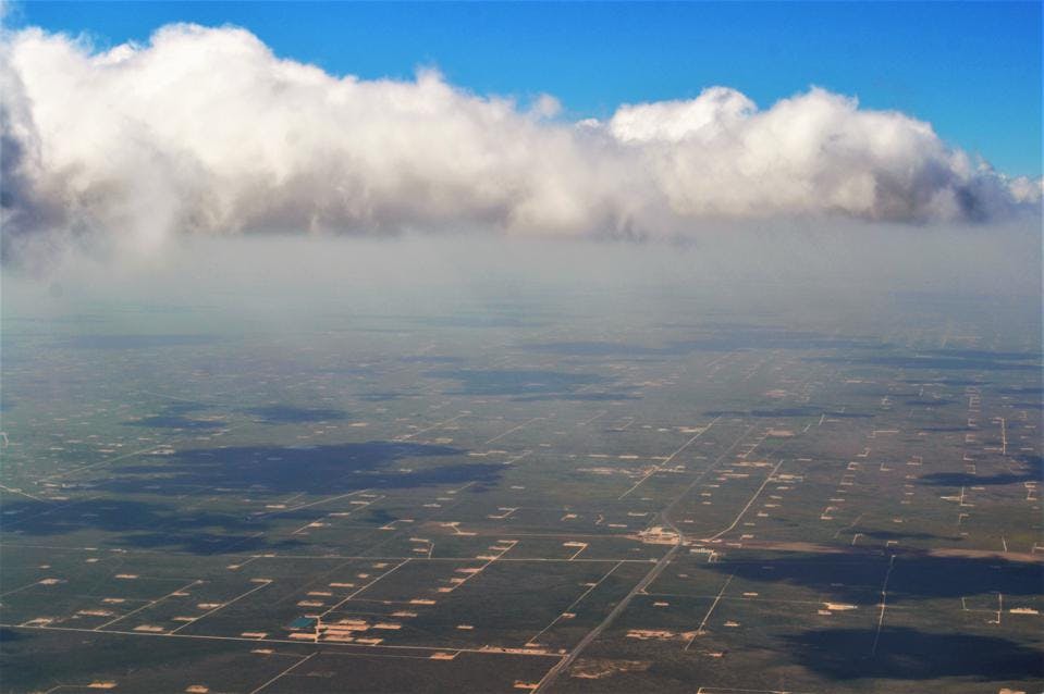 A birds eye view of the thousands of pumps, drills, and oil rigs connected by strings of dirt roads