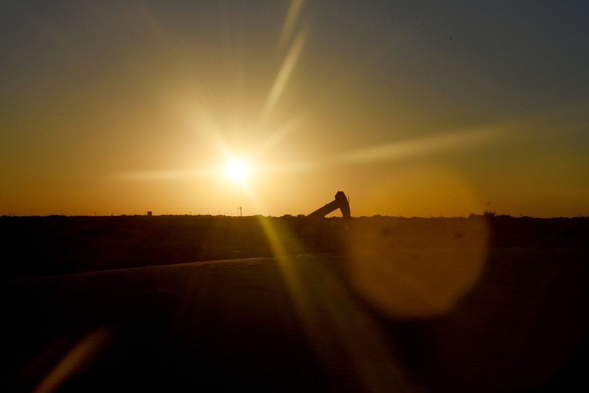 Oil pumpjack at sunset