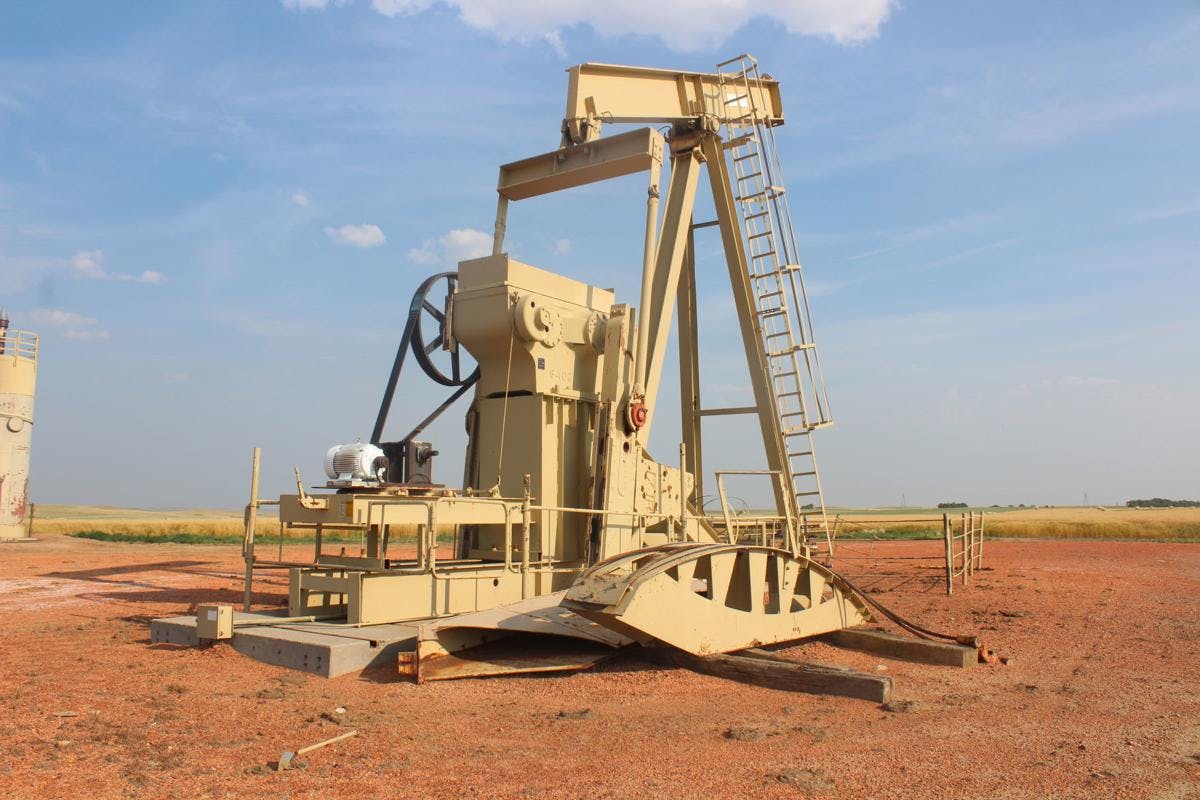 An out-of-use pumpjack sits on a well site that hasn't been reclaimed in decades.