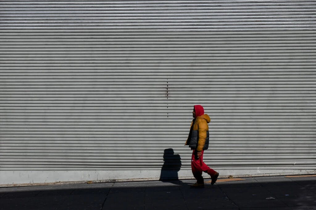 man walking sidewalk wall