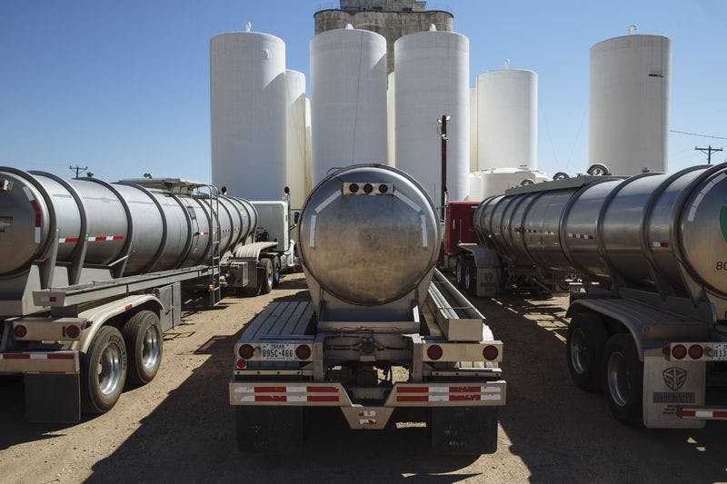Tanker trucks sit in front of storage silos in Sunray, Texas, on Sept. 26, 2020. 