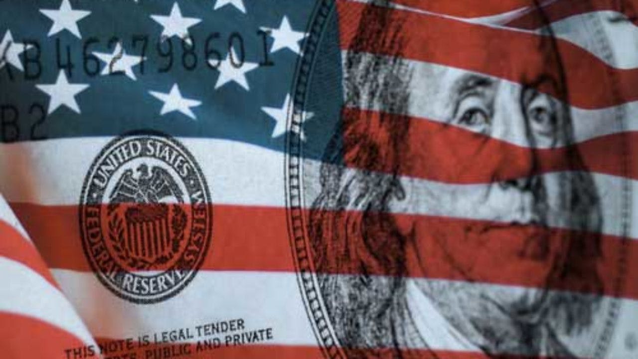 The American flag superimposed over a hundred dollar bill.