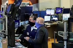 Traders at New York Stock Exchange wear masks