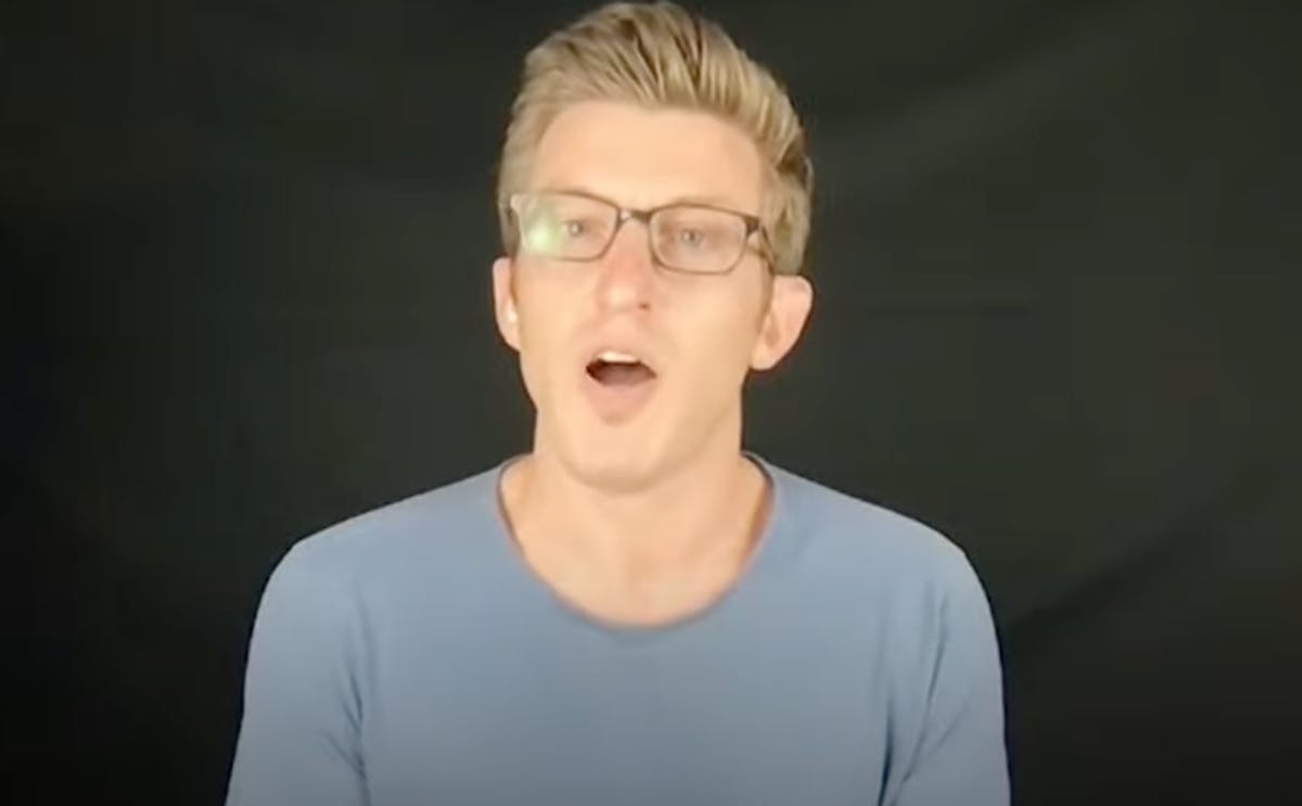 Literally the most flattering screen grab I could get of so-called philosopher Alex Epstein, wearing a t-shirt and hipster glasses, testifying in front of a charcoal dropcloth, about how fossil fuels are awesome and everyone should stop being mean to them