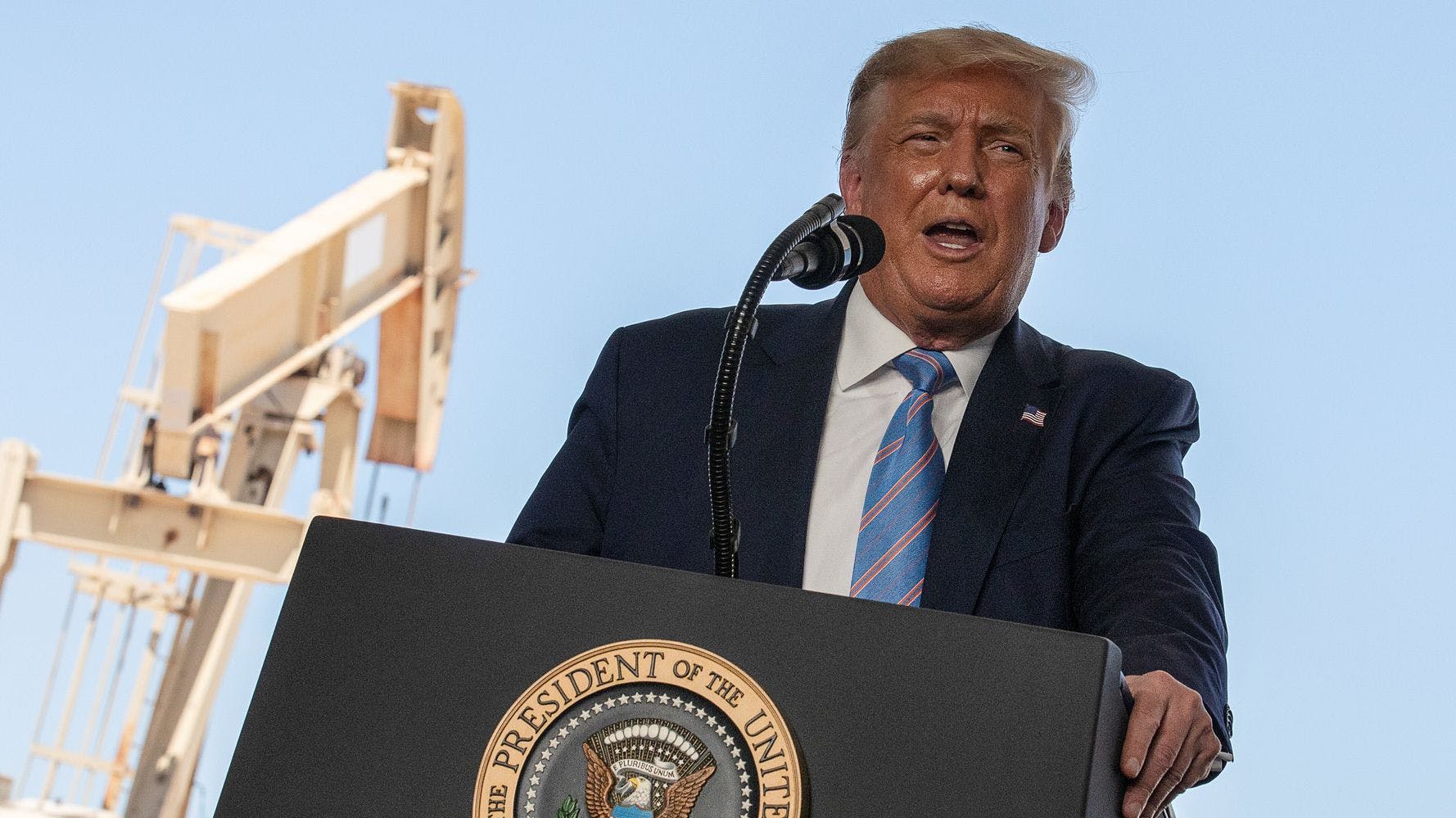 President Donald Trump speaks in front of an oil pumpjack