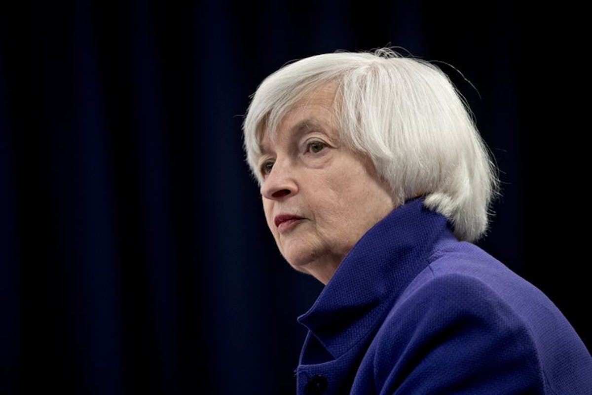 Janet Yellen looks pensive in blue.