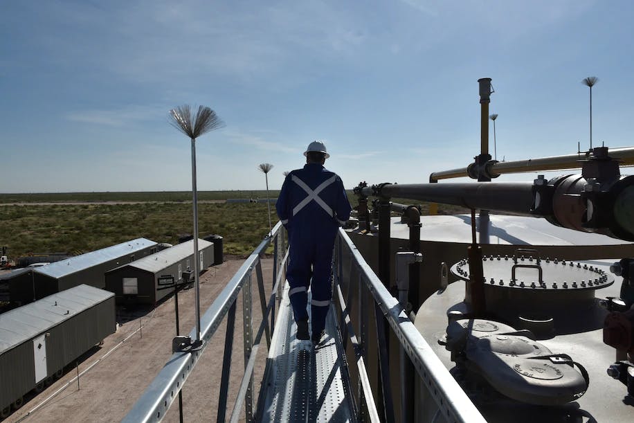 John Lee, a manager at Oasis Petroleum, walks atop a new oil production facility in Texas in 2018