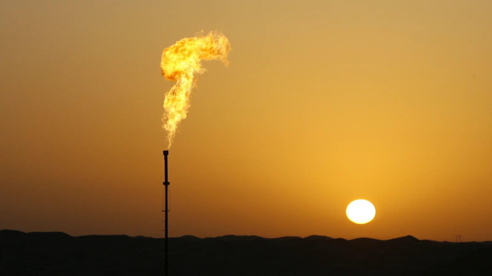 A lonely gas flare as the sun rises.