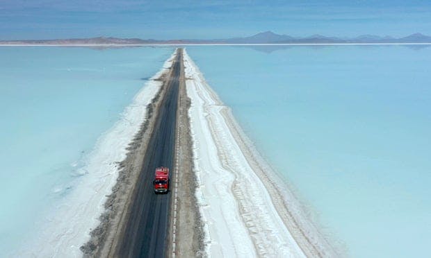 Aerial view of a truck on a road crossing the flooded southern zone of the Uyuni salt flat in Bolivia