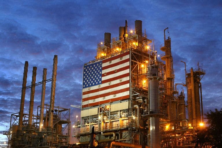 Refinery at night with American flag