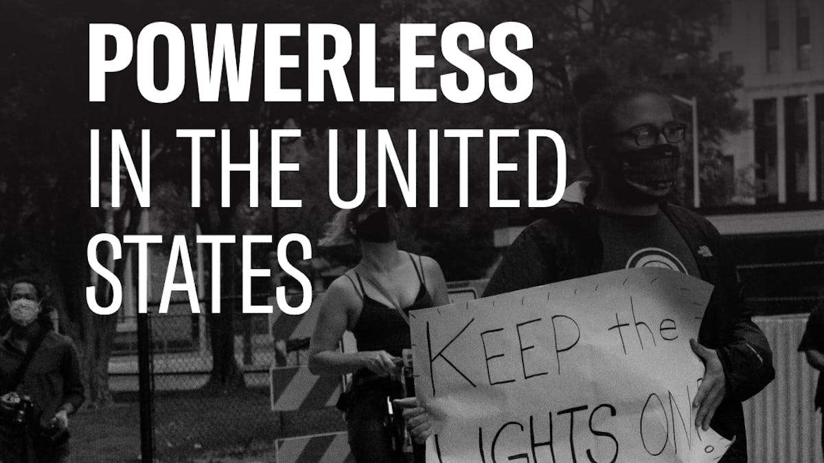 A black and white image of two protesters holding a sign that says "Keep the lights on" with text overlaid that says "Powerless in the United States"