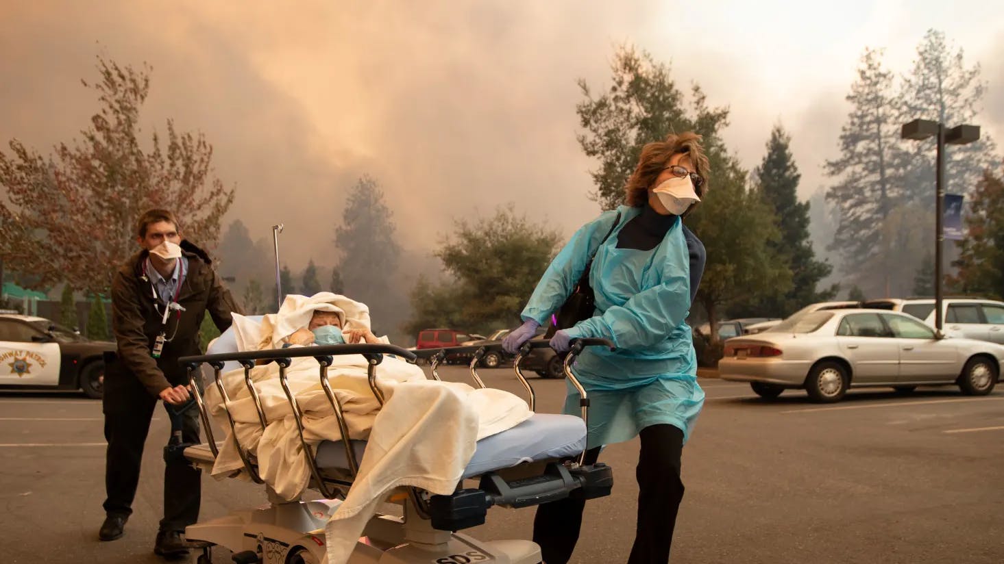 Patients are quickly evacuated from the Feather River Hospital as it burns down during the Camp fire in Paradise, California