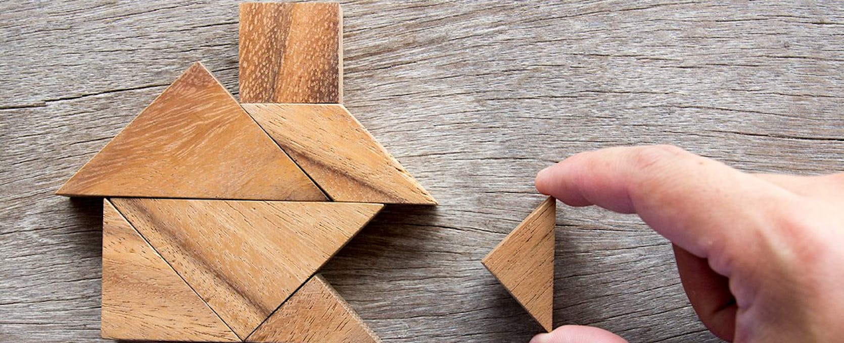 Wooden tangram puzzle in the shape of a house