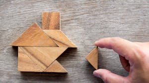 Wooden tangram puzzle in the shape of a house