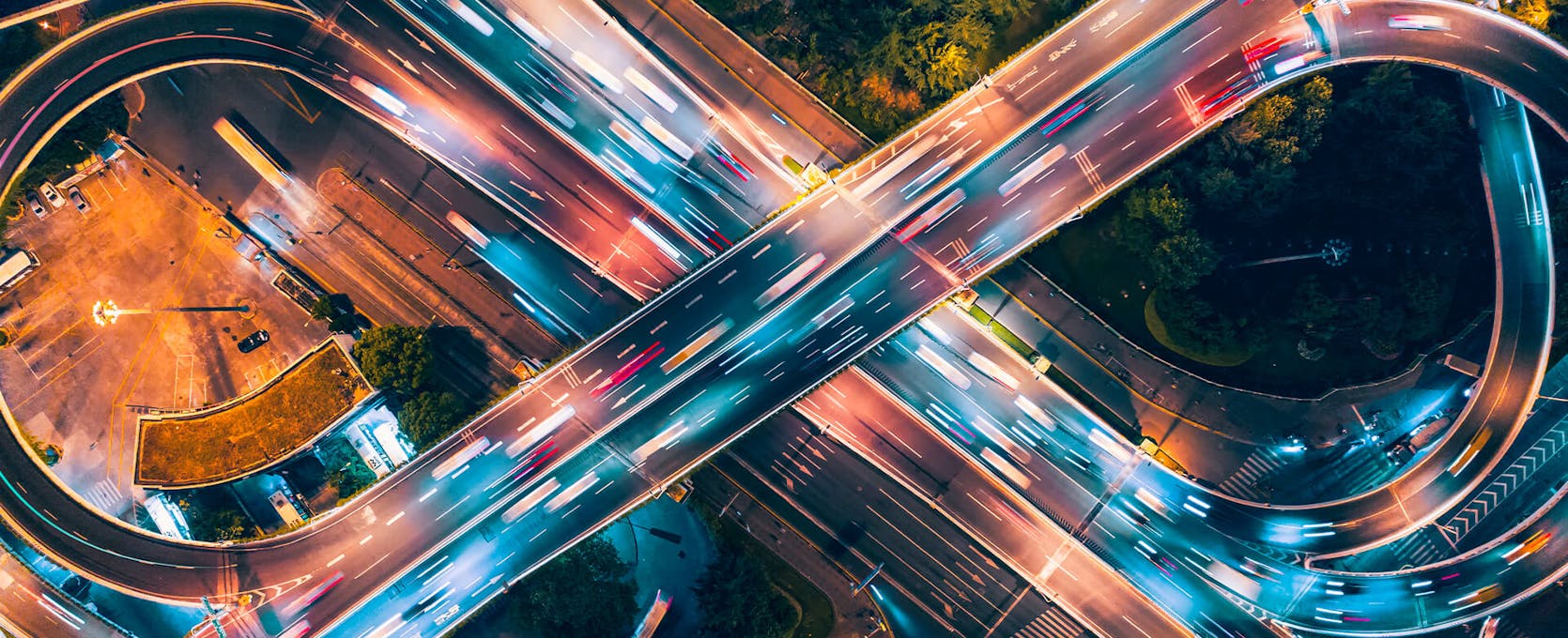 Aerial view of cars driving over highway at night