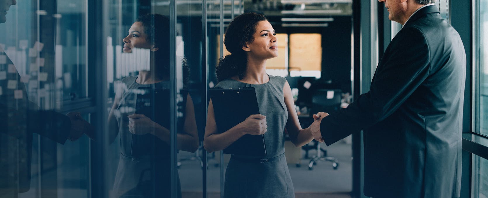 Woman shaking a mans hand at an office