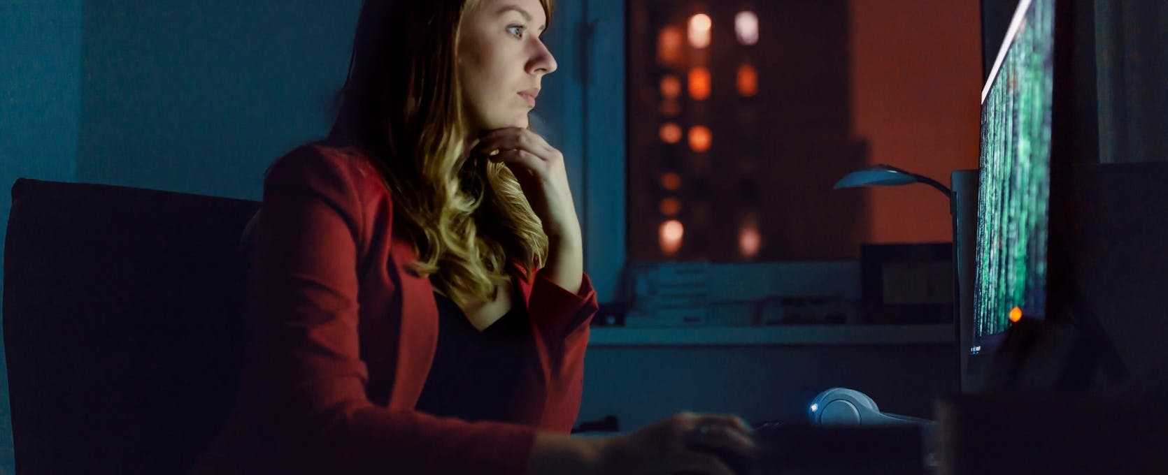 Woman works on computer at night