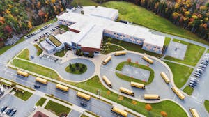 Bird eye view of a school campus with buses.