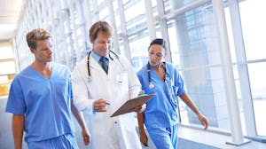 Doctors review patient's chart in an healthcare facility