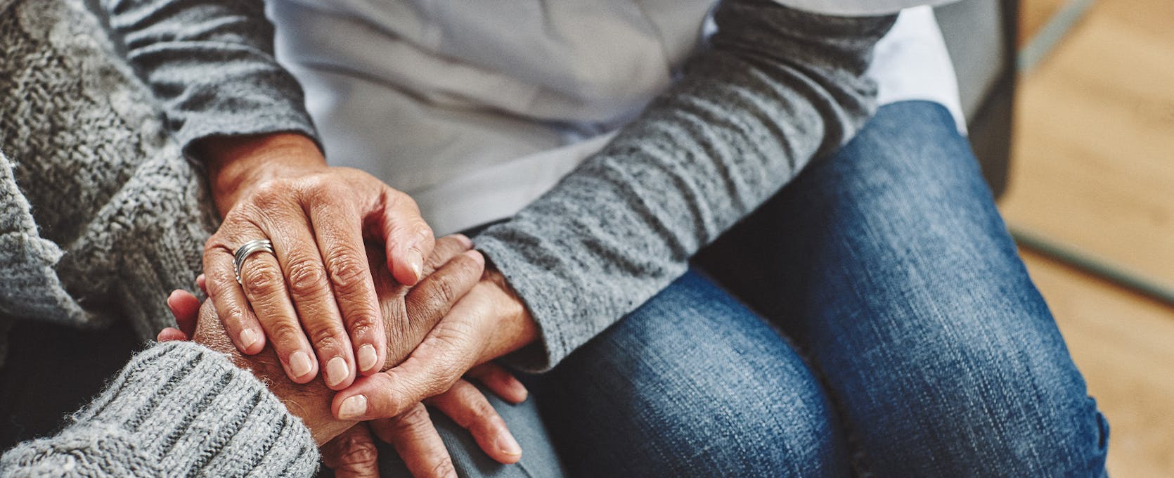 Medical professional holds the hand of patient during a consultation