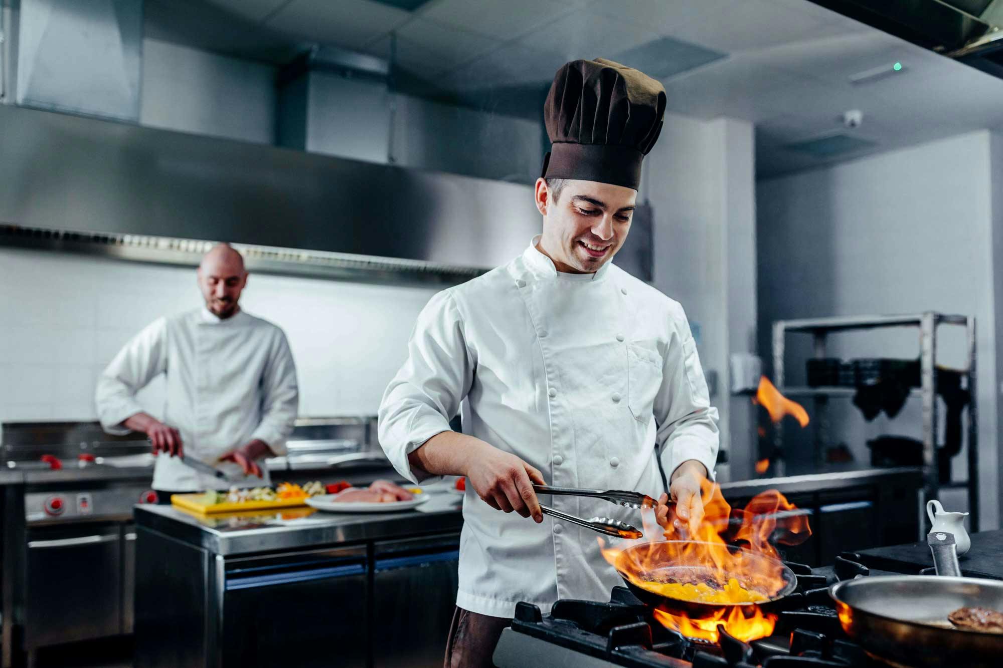 Chefs prepare meals for patron at a franchise restaurant