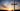 Cross in front of a sunset