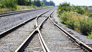 Two railroad tracks merge en route