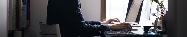 A person sitting at a desk with a laptop