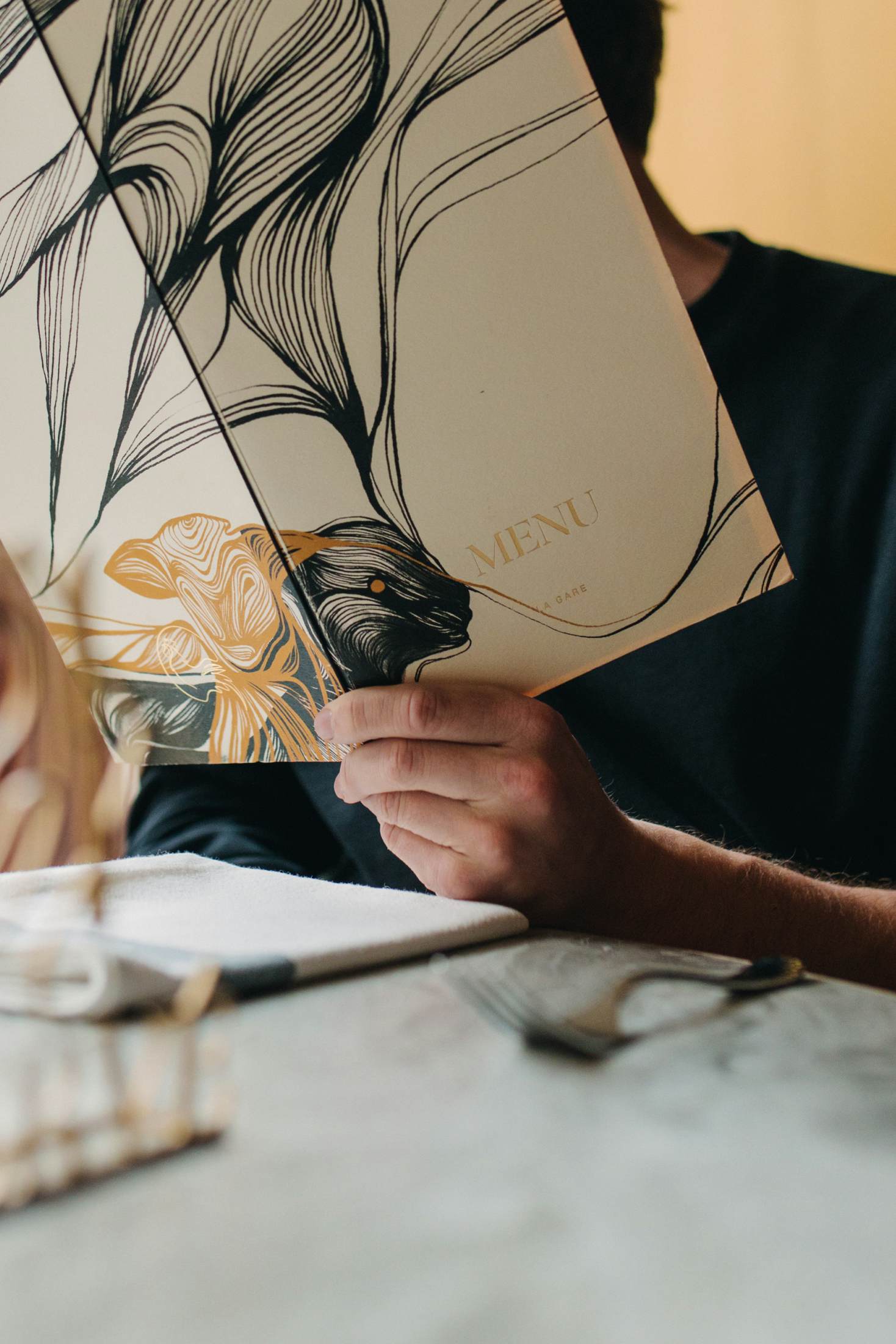 man holding an open menu