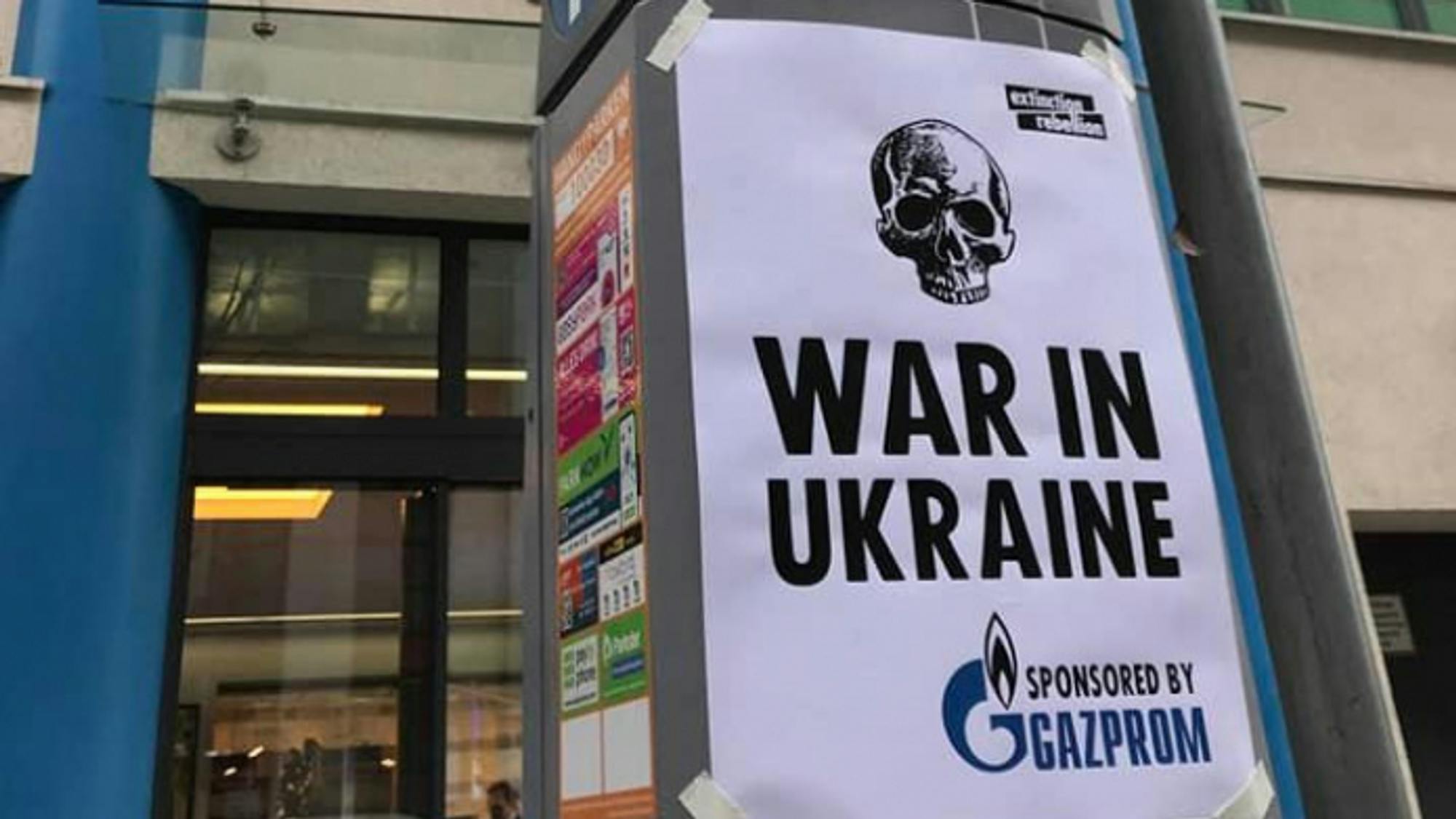 Poster by Extinction Rebellion reading "War in Ukraine – sponsored by Gazprom"
