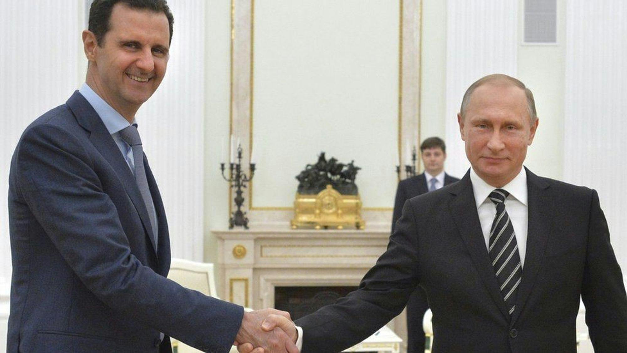 Photo of al-Assad and Putin shaking hands