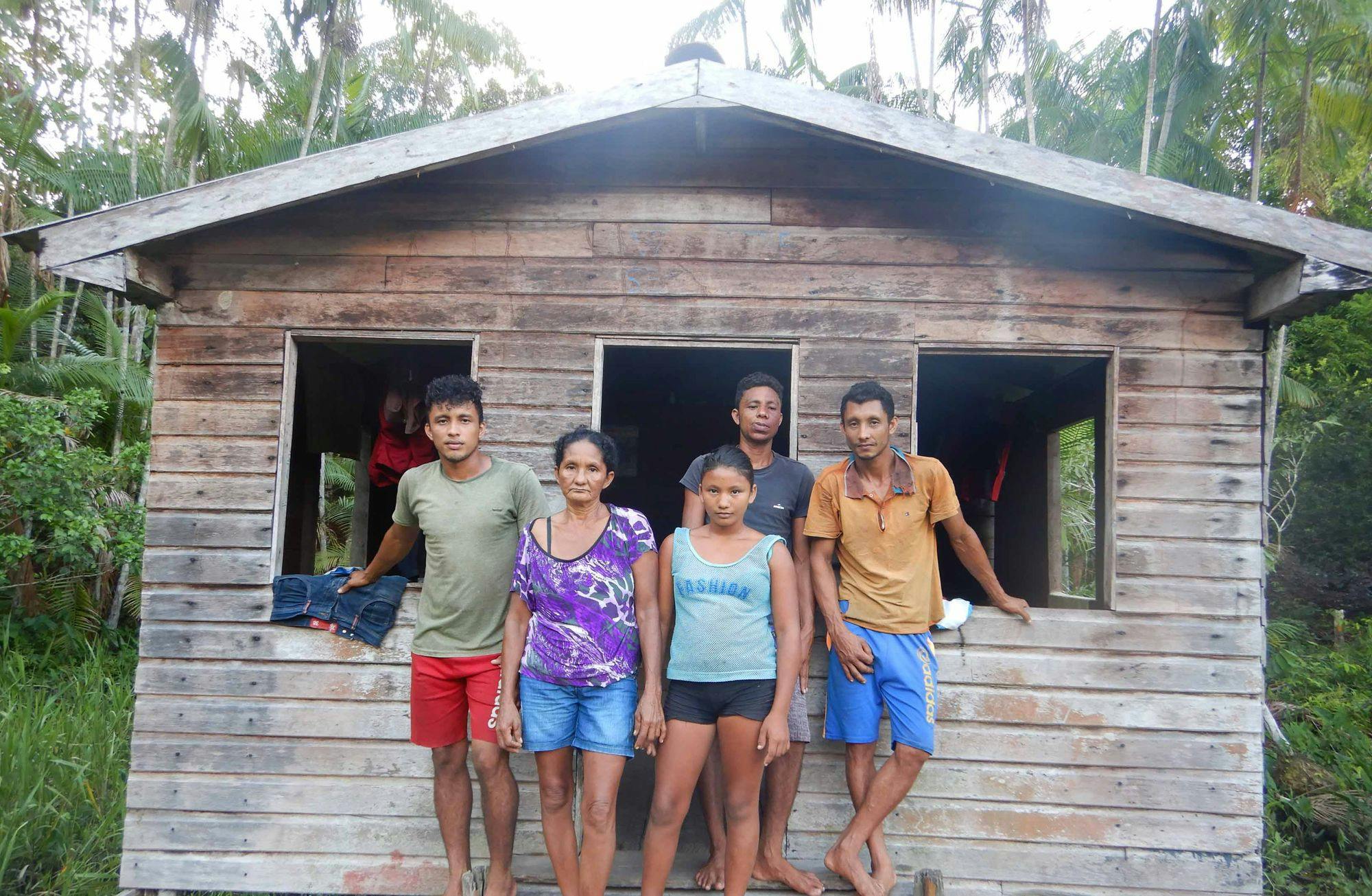 Photo of five people standing in front of a house