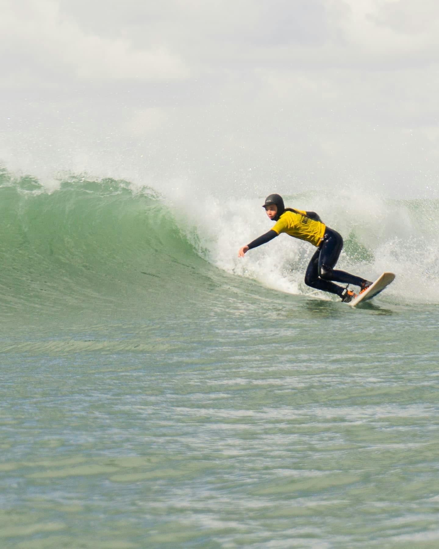 Surfing action shot cutting across wave