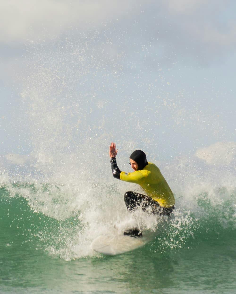 Surfer getting low with white water popping up either side of them